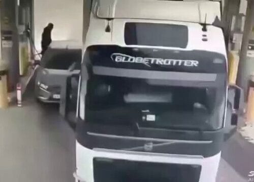 "Heroic or Hilarious? Man Takes 'Protect Your Ride' to a Whole New Level Against a Rambling Truck!"