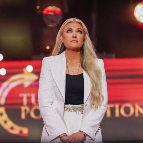 "Drama Unleashed: Protester Channels Charlie Kirk in Shocking Murder Re-Enactment at Erika Kirk's Event!"